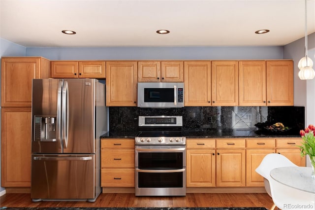 kitchen with dark wood finished floors, decorative backsplash, recessed lighting, and appliances with stainless steel finishes