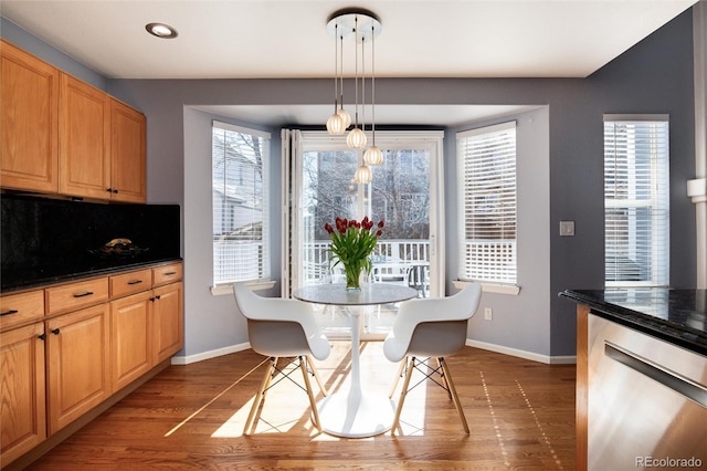 dining space featuring dark wood-type flooring, recessed lighting, and baseboards