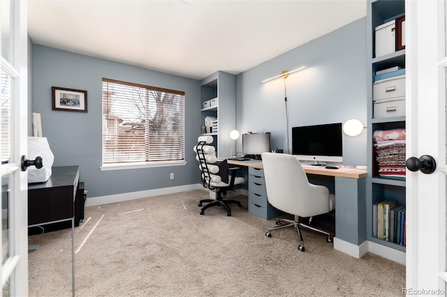 carpeted home office featuring baseboards