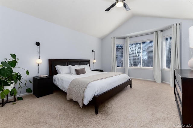 bedroom featuring light carpet, ceiling fan, baseboards, and lofted ceiling