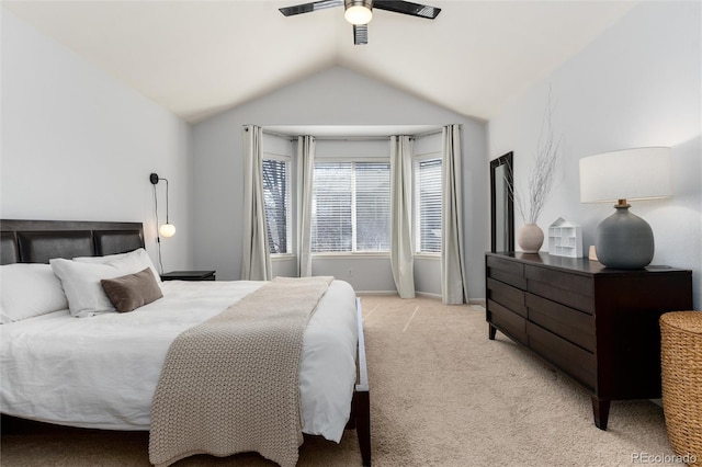 bedroom with light colored carpet, baseboards, lofted ceiling, and ceiling fan