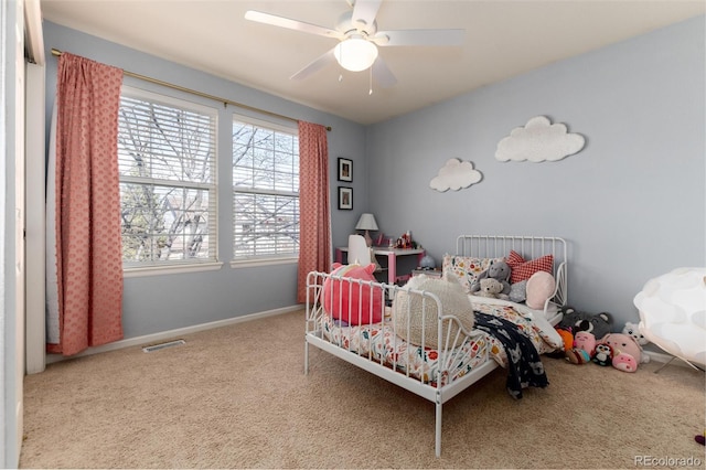 bedroom featuring visible vents, baseboards, a ceiling fan, and carpet flooring