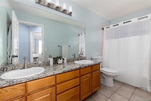 full bath featuring a sink, toilet, double vanity, and tile patterned flooring