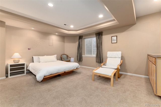 bedroom featuring recessed lighting, a tray ceiling, and baseboards