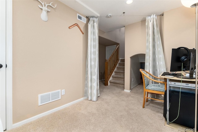 carpeted office space featuring baseboards and visible vents