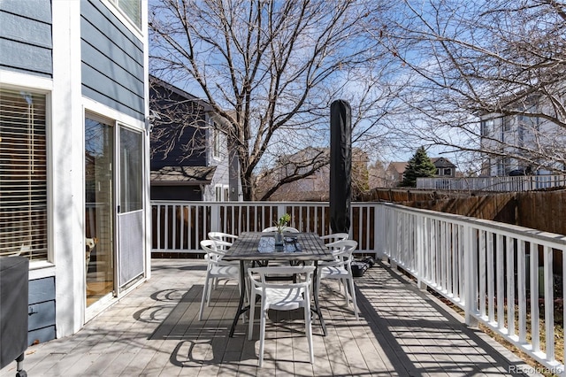 wooden deck featuring outdoor dining space and fence