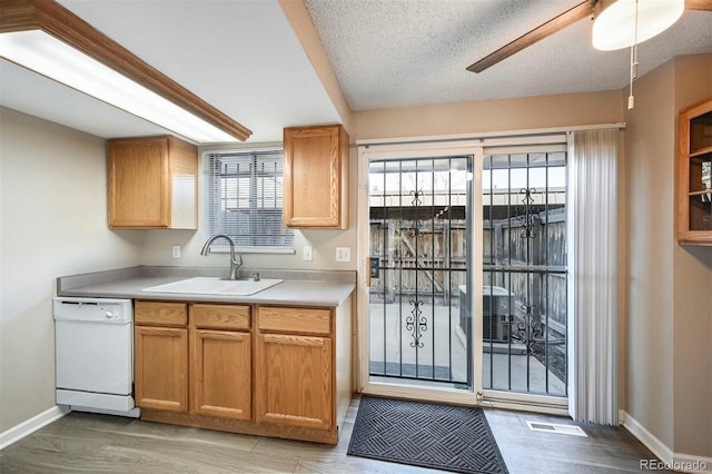 kitchen featuring a sink, visible vents, dishwasher, and a wealth of natural light