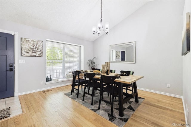 8510 Union Cir, Arvada, CO 80005 - dining space with a chandelier, light wood finished floors, and high vaulted ceiling