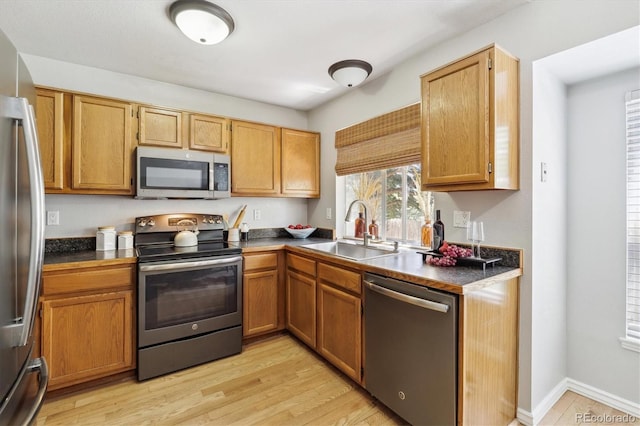8510 Union Cir, Arvada, CO 80005 - kitchen with appliances with stainless steel finishes, dark countertops, and light wood finished floors