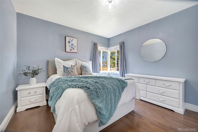 bedroom with dark wood-type flooring