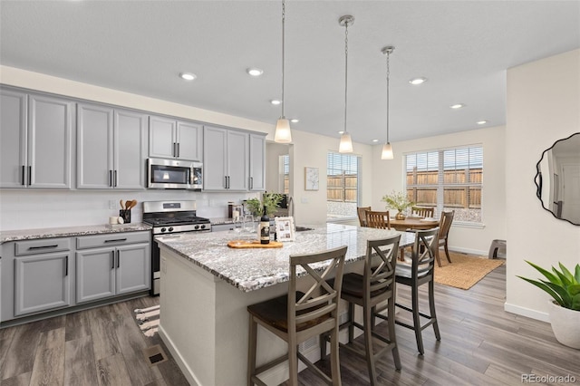 1061 S De Gaulle Ct, Aurora, CO 80018 - kitchen with appliances with stainless steel finishes, gray cabinets, dark wood finished floors, and recessed lighting
