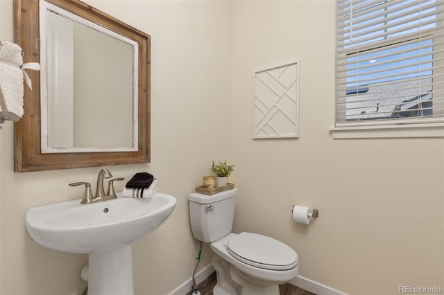 1061 S De Gaulle Ct, Aurora, CO 80018 - half bathroom with baseboards and wood finished floors