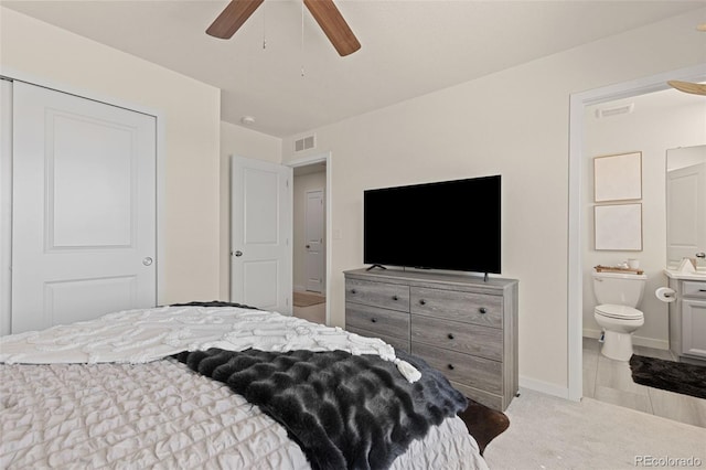 1061 S De Gaulle Ct, Aurora, CO 80018 - bedroom featuring ensuite bathroom, light colored carpet, and a ceiling fan