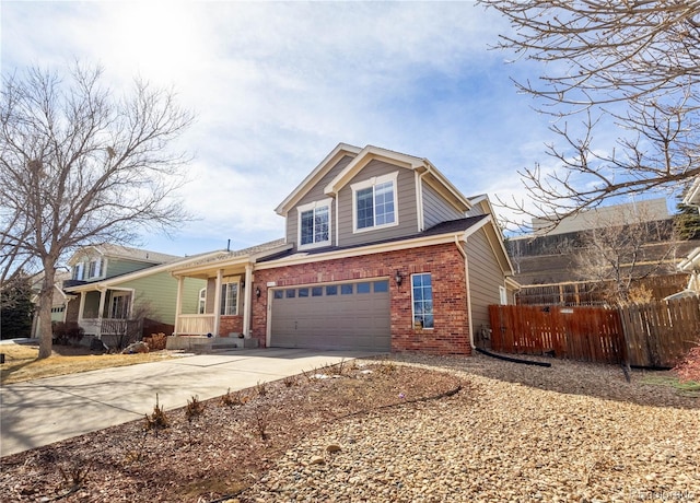 view of front facade with a garage, concrete driveway, brick siding, and fence