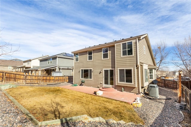 back of property with a patio, a lawn, central AC unit, entry steps, and a fenced backyard