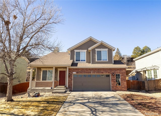 view of front of home with driveway, brick siding, and fence