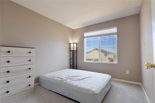 bedroom featuring carpet floors and baseboards