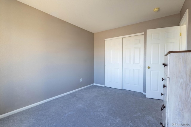 unfurnished bedroom with a closet, carpet, and baseboards