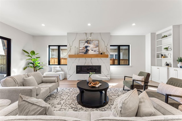 living room featuring a premium fireplace and light hardwood / wood-style floors