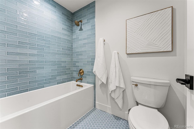 bathroom with tiled shower / bath combo, tile patterned flooring, and toilet