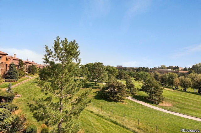 view of community with a yard and a rural view