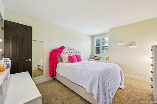 bedroom featuring carpet flooring and baseboards