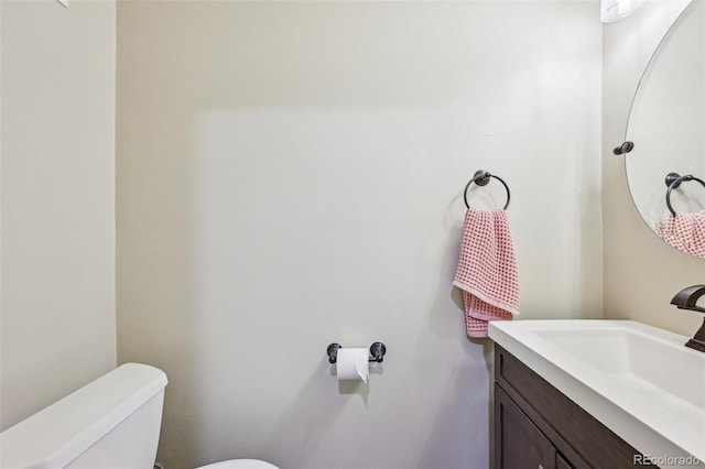 bathroom with toilet and vanity
