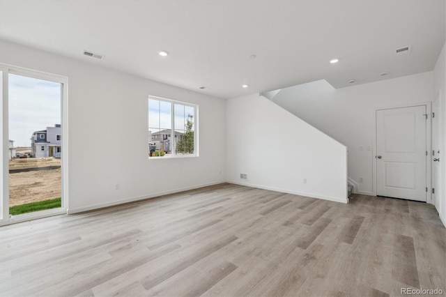 6646 N Nepal St, Aurora, CO 80019 - unfurnished living room with light wood-style floors, recessed lighting, baseboards, and stairway