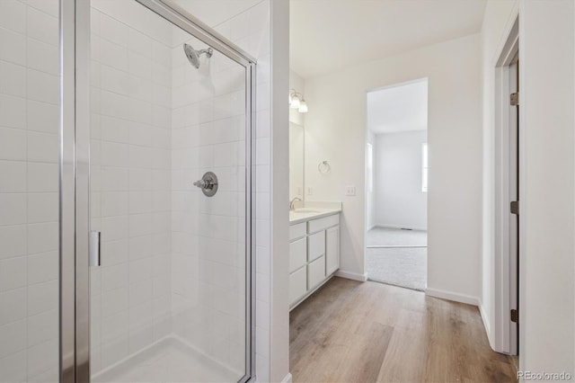 6646 N Nepal St, Aurora, CO 80019 - bathroom featuring a shower stall, wood finished floors, and vanity