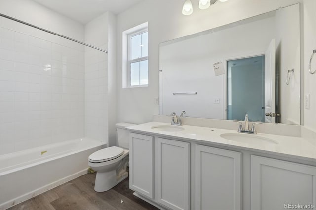 6646 N Nepal St, Aurora, CO 80019 - full bath with wood finished floors, toilet, double vanity, and tub / shower combination