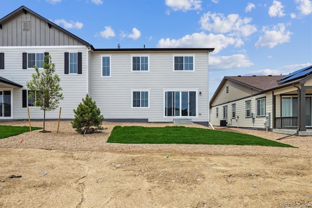 6646 N Nepal St, Aurora, CO 80019 - back of house featuring central AC and board and batten siding