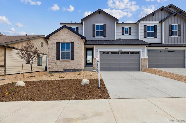 6646 N Nepal St, Aurora, CO 80019 - view of front facade with board and batten siding, an attached garage, brick siding, and driveway