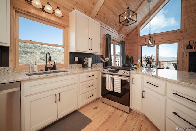 577 Gcr 8952, Granby, CO 80446 - kitchen featuring appliances with stainless steel finishes, light wood-type flooring, a wood ceiling with exposed beams, wood walls, and light stone countertops