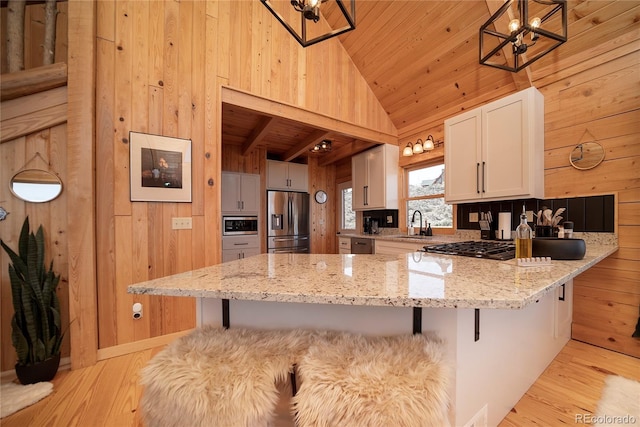 577 Gcr 8952, Granby, CO 80446 - kitchen with appliances with stainless steel finishes, lofted ceiling, a chandelier, wooden walls, and wooden ceiling