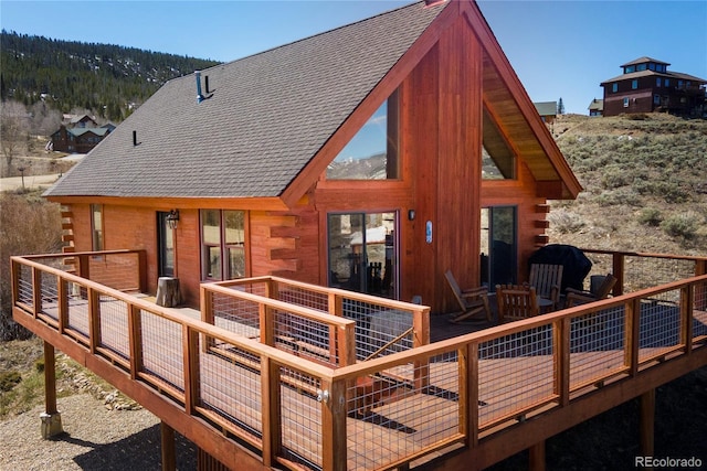 577 Gcr 8952, Granby, CO 80446 - back of house with log siding, a wooden deck, and a shingled roof