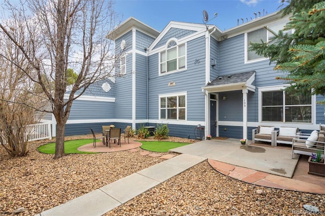 rear view of house featuring a patio and fence