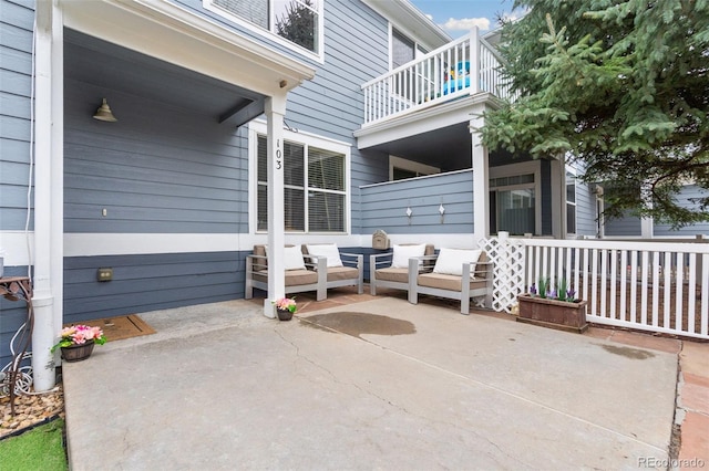 view of patio featuring an outdoor hangout area and a balcony