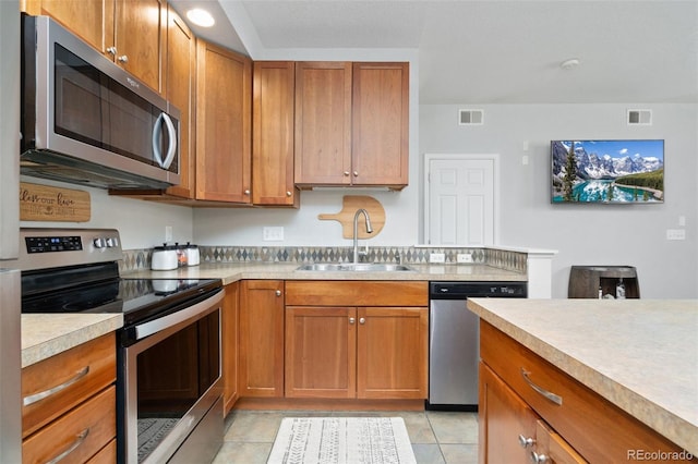 kitchen featuring light countertops, visible vents, appliances with stainless steel finishes, and a sink