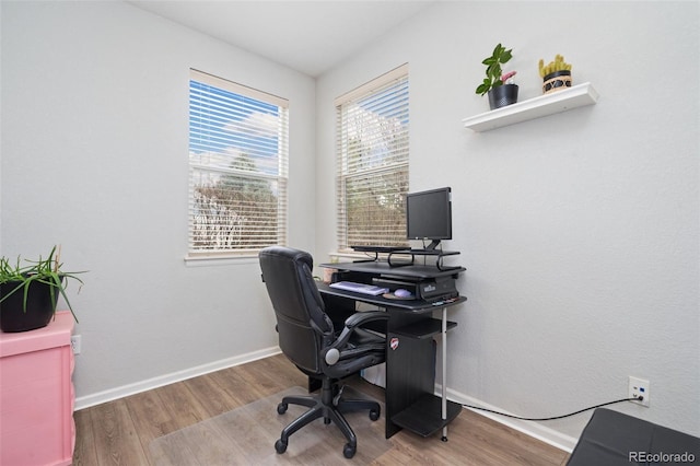 home office featuring baseboards and wood finished floors