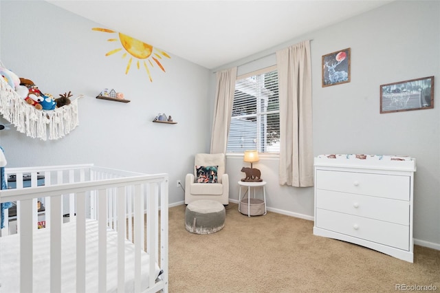 carpeted bedroom with baseboards and a crib