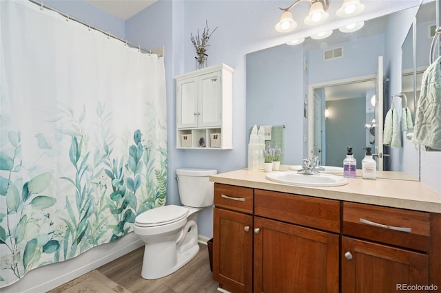 full bath featuring vanity, shower / bathtub combination with curtain, wood finished floors, visible vents, and toilet