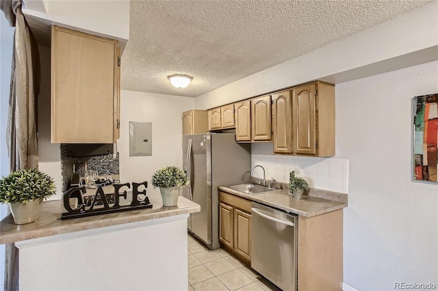 kitchen featuring electric panel, sink, decorative backsplash, light tile patterned floors, and appliances with stainless steel finishes