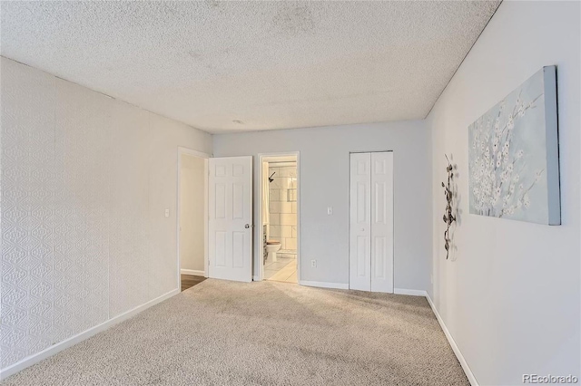 carpeted spare room with a textured ceiling