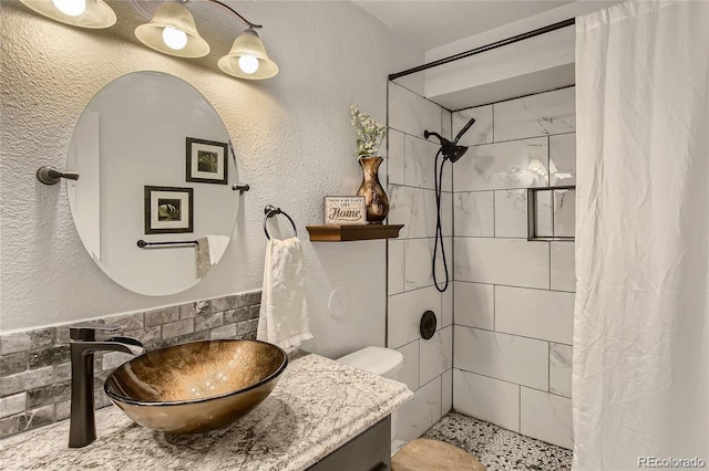 bathroom with vanity, curtained shower, and toilet