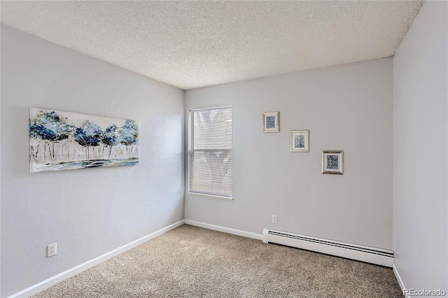 empty room featuring carpet flooring, a baseboard radiator, and a textured ceiling