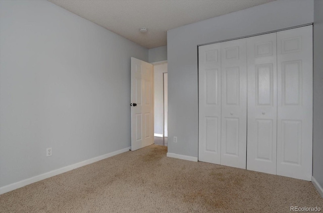 unfurnished bedroom featuring carpet floors and a closet