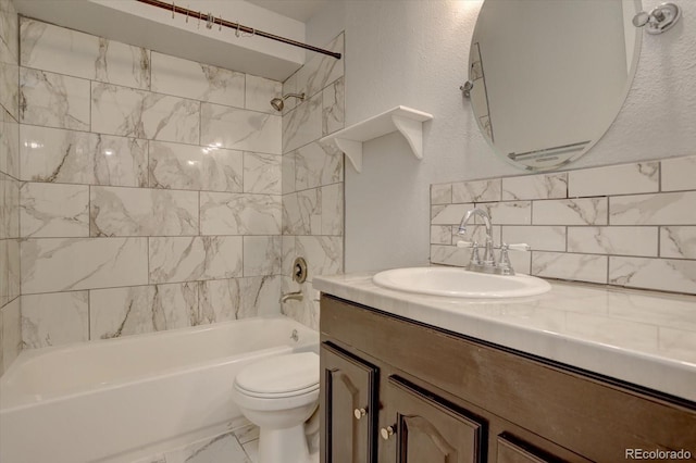 full bathroom with tasteful backsplash, toilet, vanity, and tiled shower / bath