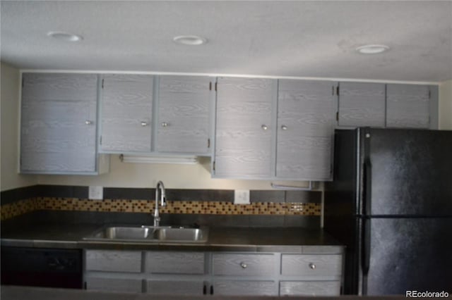 kitchen featuring black fridge and sink