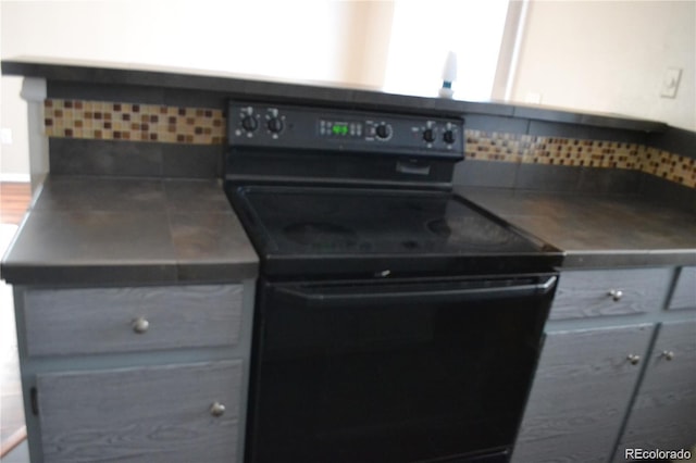 kitchen with electric range and gray cabinets