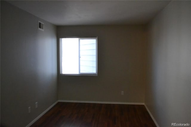 spare room featuring dark hardwood / wood-style floors